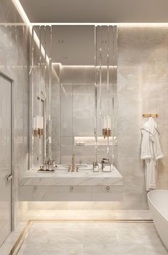 a bathroom with a tub, sink and shower in the center is illuminated by recessed lighting