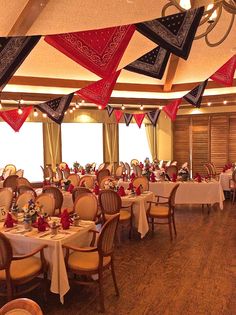 a dining room with many tables and chairs covered in red, white and blue decorations