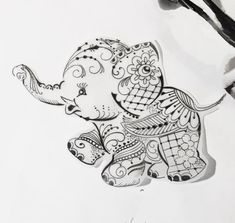 an elephant with intricate designs on it's body is shown in black and white