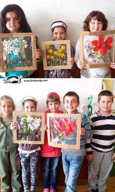 the kids are holding up their paintings in front of them and posing for pictures with each other