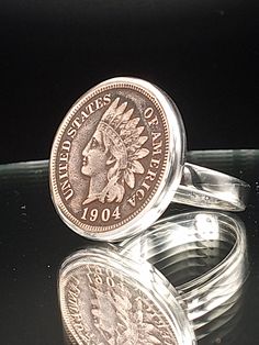 This Indian Head Penny ring is entirely hand built using thick, heavy gauge solid .925 sterling silver and .999 fine silver, made to order in your size for a perfect fit.  Each setting is hand built for each specific coin for the optimum fit and finish. The ring is meticulously hand polished to a mirror shine for a smooth, comfortable feel on the finger.  I use genuine vintage Indian Head pennies, grade good or better, locally sourced and hand selected. I bezel set the coin using traditional sil Penny Ring, Silversmith Techniques, Penny Bracelet, Silver Coin Ring, Coin Rings, American Coins, Indian Head, Ring Mens, Rings Silver