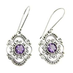 Amethysts the February??s birthstone center ornate mosaics of Indonesian elegance in earrings by Buana. He crafts the earrings by hand with sterling silver and 3 gemstone carats. .925 Sterling silver Ornate Purple Sterling Silver Earrings, Ornate Purple Dangle Earrings, Ornate Purple Drop Earrings, Ornate Purple Pierced Earrings, Ornate Purple Dangle Jewelry, Purple Earrings With Intricate Design As Gift, Ornate Purple Jewelry With Matching Earrings, Purple Earrings With Intricate Design For Gift, Purple Filigree Round Jewelry