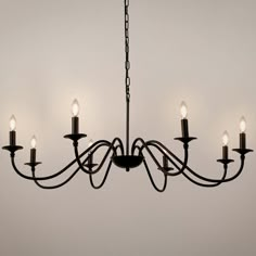 a chandelier with five lights hanging from it's center and four arms