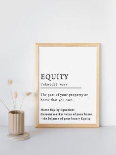 there is a vase with some flowers in it next to a framed poster that says, equity