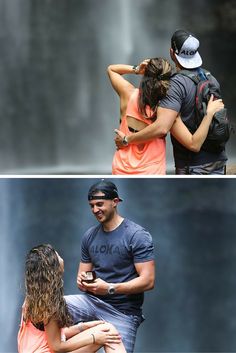 two people standing next to each other in front of a waterfall and one person holding his arm around the other