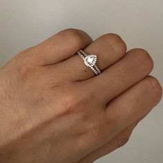 a person's hand with a diamond ring on it