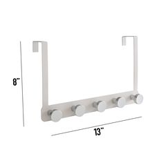 a white wall mounted towel rack with four round knobs and three circles on each side