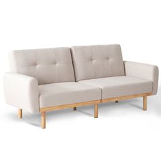 two white couches sitting next to each other in front of a white wall and floor