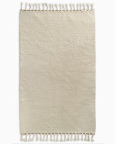 a white rug with fringes on the bottom and one side is folded in half