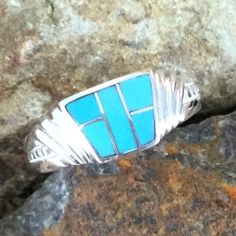 This beautiful Sterling Silver Ring, as part of the Arizona Blue Collection, features Kingman Turquoise. Ring Width: 3/8"; Ring Shank: 1/8" The ring is designed by David Rosales, one of the finest contemporary Southwest Artists in the world. He is the founder and co-owner of Supersmiths, Inc. of Gallup, NM. Each ring is custom made and carries a lifetime guarantee. Contemporary Southwest, Arrow Jewelry, Black Arrow, Southwest Jewelry, Kingman Turquoise, Jewelry Designer, American Made, Sterling Silver Ring, Jewelry Art