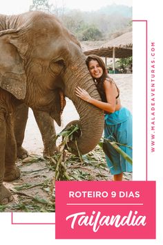 a woman standing next to an elephant with her trunk on top of it's head