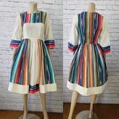 "This vintage 50s/60s era swing dress features a rainbow serape stripe print and off-white muslin fabric, modest bodice, cropped bell sleeves, nipped waist, and full pleated skirt. Dress is pictured with a crinoline underneath (not included). Dress is unlined and zips up the back. Bodice is slightly sheer, so you may want to wear a camisole beneath. Best fits size xxs, xs, or small (please refer to measurements below). Accessories not included.  Approximate Flat Measurements:  Multiply times 2 f Dancing Skirt, Patio Dress, Pleated Skirt Dress, Swing Dancing, Muslin Fabric, Skirt Dress, White Fabrics, Dress Clothes For Women, Swing Dress