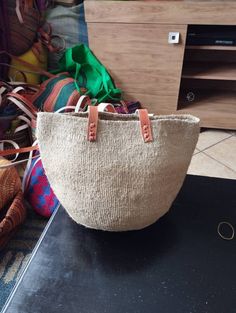 "Beige sisal tote bag DIMENSIONS Bottom width: 10\"/25.5cm Top width: 14\"/35.56cm Depth: 10\"/25.5cm Straps: 15\"/38cm SHIPPING All orders ship via DHL Express (3-5) days delivery time." Handwoven Bag, African Basket, Woven Handbags, Maasai, Woven Basket, Handmade Bag, Basket Bag, Dhl Express, Hobo Bag