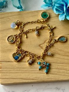 Floral personalized .925 silver gold plated various blue flowers, double chain charm bracelet, real blue dried flowers charm, initial charm, heart charm with blue flowers, rhinestone charms, acrylic blue bead charm, lobster claw clasp, moonstone charm, perfect for Mother's Day gifts, birthday gifts, wedding gift ("something borrowed, something blue"), this bracelet is 7 inches in length. Blue Heart Charm Jewelry As Gift, Blue Heart Charm Jewelry As A Gift, Blue Heart Charm Jewelry Gift, Blue Heart Charm Jewelry For Gift, Blue Jewelry With Heart Charm For Gifting, Hypoallergenic Gold Plated Jewelry For Mother's Day, Metal Charm Jewelry As A Gift For Her, Gold Charm Bracelet With Lobster Clasp For Mother's Day, Dainty Gold Plated Dangle Charm Bracelet