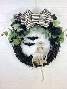 a wreath with a skeleton and leaves on it