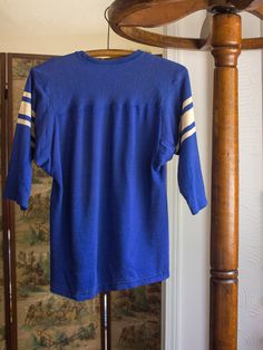 a blue shirt hanging on a clothes rack