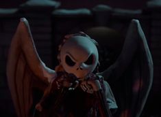 the skeleton doll is standing in front of a fire place with its wings spread out