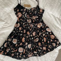 This Is A Dress From American Eagle Outfitters New With Tags Women's Size 4 Black With White And Pink Floral Pattern Adjustable Spaghetti Straps Mini Length Side Zipper Closure Criss Cross Tie In Back Summer Dress Measures Approx 15 Inches Across Bust Measures Approx 30 Inches In Length Black Mini Dress With Spaghetti Straps For Spring, Black Floral Print Summer Sundress, Black Mini Sundress For Spring, Black Dress With Adjustable Straps For Summer, Black Mini Sundress With Adjustable Straps, Black Sundress With Adjustable Straps For Brunch, Black Floral Print Sundress For Party, Black Floral Print Party Sundress, Casual Dress With Adjustable Straps For Date Night