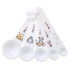 four spoons with winnie the pooh stickers on them