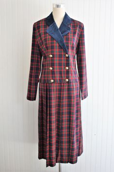 "This dress is of cotton blend plaid with velvet bllue collar.   The gold button on the drop waist bodice give the garment a flattering line.   It is without holes or stains , in very good to excellent condition Marked size 12 40\" bust 36\" waist 42\" at drop waist full hip 38\" nape to hem  Purveyor's Note: We have searched far and wide, wrestled bears, braved the cold, traversed mountain ranges, fought pirates, swam with sharks and eaten at many a questionable road side taco stand to provide our customers with one of a kind vintage pieces.  Know that whichever piece you choose to make your own has its own story and has traveled through time to get to you.  Though we strive to provide the absolute best, \"pristine\" vintage pieces are rare birds, if not altogether non-existent.  That bei Fitted Plaid Dress With Buttons For Work, Fitted Plaid Dress With Buttons For Fall, Classic Fitted Plaid Dress With Buttons, Formal Fitted Plaid Dress, Classic Plaid Dress With Buttons, Taco Stand, Velvet Collar, Mountain Ranges, Vintage Pieces