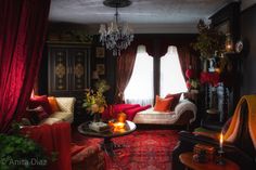 a living room filled with furniture and a chandelier