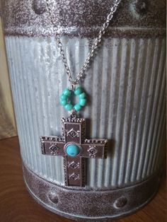 This necklace features a western style cross with a turquoise accent. Bohemian Turquoise Cross Necklace, Bohemian Turquoise Cross Pendant Necklace, Cross Charm Necklace, Turquoise Accents, Charm Necklaces, Cross Jewelry, Cross Charms, May 1, Western Style