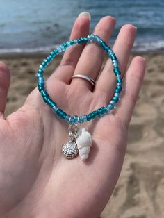 A very beach seashell bracelet set with turquoise colored beads. The set includes two turquoise beaded bracelets with seashell charms! Bracelet 1: Silver starfish charm and silver clam shell charm Bracelet 2: White seashell charm and silver seashell charm A perfect bracelet set for beach lovers! Beachy Charm Bracelet, Cheap Beaded Bracelets With Heart Beads For Beach, Shell Charm Bracelet, Beach Beads Bracelets, Sea Shells Bracelet, Turquoise Beaded Bracelets With Starfish Charm, Turquoise Ocean-inspired Bracelet With Starfish Charm, Ocean-inspired Turquoise Bracelet With Starfish Charm, Ocean-inspired Turquoise Beaded Bracelets For Gift