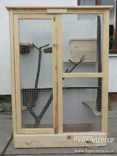 a large bird cage sitting on top of a sidewalk