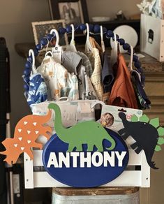 an assortment of personalized items are displayed on a table in front of a baby's crib