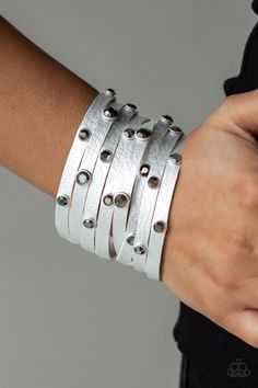 Brushed in a metallic shimmer, a thick gray leather band has been spliced into eight strips across the wrist. Encased in sleek silver fittings, glittery hematite rhinestones are sprinkled across the center for a sassy finish. Features an adjustable snap closure. Sold as one individual bracelet. P9DI-URSV-128XX Silver Wrap Bracelet, Snap Bracelets, Jewelry Show, Paparazzi Accessories, Gray Leather, Rhinestone Studs, Paparazzi Jewelry, Leather Wrap Bracelet, Studded Leather