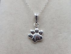 Sterling Silver Paw Print Charm Pendant Necklace the paw print pendant measures 13mm x 10mm material: sterling silver. Elegant Sterling Silver Paw Print Necklace, Elegant Sterling Silver Necklace With Paw Print, Silver Paw Print Jewelry For Anniversary, Silver Jewelry With Paw Print, Silver Jewelry With Paw Print For Anniversary, Silver Anniversary Jewelry With Paw Print, Silver Paw Print Round Pendant Necklace, Sterling Silver Paw Print Necklace For Gift, Sterling Silver Paw Print Necklace As Gift