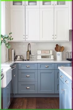 a kitchen with blue cabinets and white counter tops