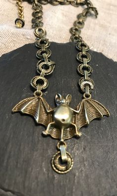 "Vintage Bat interesting brass original necklace design.  Condition I see no problems, patina from age.  Size length 16\", with extra 2\" extender.  Creature of the night.  Fantasy bat in flight. Halloween, good luck symbol!" Gothic Metal Necklace With Antique Finish, Collectible Metal Necklace With Antique Finish, Bronze Metal Necklace With Antique Finish, Bronze Antique Finish Metal Necklace, Vintage Metal Necklace With Patina, Collectible Bronze Metal Necklace, Vintage Patina Metal Necklace, Victorian Bronze Metal Necklaces, Bronze Steampunk Metal Necklace