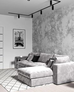 a living room with a couch, coffee table and pictures on the wall