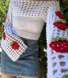 a close up of a person wearing a crocheted scarf