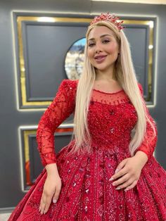 a woman in a red dress posing for the camera with her hands on her hips