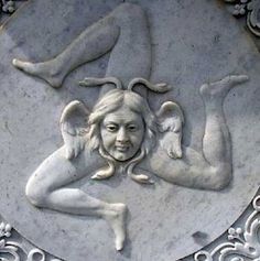 a white plaque with an image of a woman and two cherubs on it