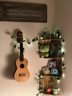 two shelves with stuffed animals and an ukulele hanging on the wall next to them