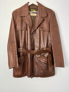 "Vintage genuine leather brown pocketed belted jacket, long sleeves, button up closure. Brand: Vinson Made in Sweden Size on tag: 100 Material: genuine leather Would fit sizes s, m, l - depending on desired fit Measured laying flat: 31 1/2\", 80 cm long 23\", 58.5 cm armpit to armpit 18 3/4\", 47.5 cm shoulders seam to seam 23 1/2\", 59.5 cm sleeve length Some colour spots at the right side of jacket's bottom, please see photos, otherwise great vintage condition. If you have any questions, pleas Brown Belted Leather Jacket With Long Sleeves, Vintage Long Sleeve Belted Outerwear, Vintage Brown Leather Jacket With Flap Pockets, Vintage Brown Single-breasted Leather Jacket, Vintage Brown Leather Jacket With Buttons, Retro Brown Single Breasted Leather Jacket, Retro Brown Single-breasted Leather Jacket, Retro Brown Leather Jacket With Buttons, Brown Single Breasted Retro Leather Jacket