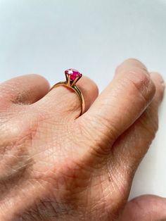 This is a gorgeous vintage 1970s 14 karat yellow gold high set hot pink tourmaline ring. The tourmaline stone is 1.25 carats. The band is 14 K. The stone rises 1/4 inch from the base of the ring. The ring is a size 8. It must have been resized at one point because only part of the gold mark is visible. It has been acid tested and guaranteed 14 K. The stone color is a beautiful deep hot pink. This would make a beautiful engagement ring for that someone special or a perfect ring to wear for that s Fine Jewelry Yellow Gold Ruby Ring For Proposal, Classic Ruby Rings With Round Cut, Classic Round Band Lab-created Ruby Jewelry, Yellow Gold Ruby Ring For Proposal, Ruby Birthstone Ring In Round Cut, Classic Lab-created Ruby Round Band Jewelry, Anniversary Ruby Ring With Center Stone In Round Band, Yellow Gold Birthstone Ring With Round-cut Lab-created Ruby, Yellow Gold Birthstone Ring With Round Cut Lab-created Ruby