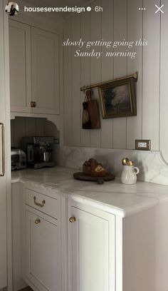 a kitchen with white cabinets and marble counter tops is featured in the magazine house & design