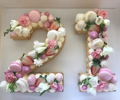 the number twenty seven decorated with flowers and fruit is shown in front of a white wall