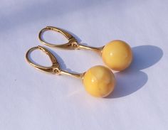 "Gorgeous earrings in natural Baltic amber, set in gold-plated sterling silver setting. Butterscotch color stone. Ball's diameter: 0.45\"  Weight = 4.6 gram" Classic Round Cabochon Earrings, Yellow Gold Cabochon Drop Earrings, Yellow Gold Cabochon Earrings, Yellow Gold Cabochon Round Earrings, Yellow Gold Round Cabochon Earrings, Gold Teardrop Cabochon Jewelry, Classic Gold Cabochon Earrings, Elegant Yellow Earrings With Polished Finish, Gold Cabochon Drop Earrings