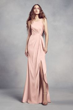 a woman in a pink dress posing for the camera