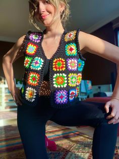 a woman in black pants and a colorful crochet top