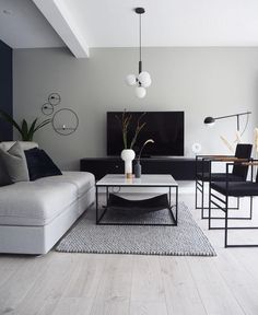 a living room filled with furniture and a flat screen tv on top of a wooden floor