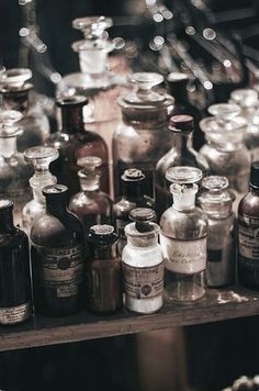 many bottles are lined up on a shelf