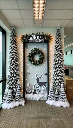 an office decorated for christmas with fake trees and wreaths on the front door,