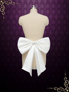 the back of a mannequin with a white bow on it