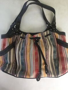 You are purchasing a brand new Caribbean Joe Purse tote bag. 2 side pockets on outside. Inside has one zippered pouch plus 2 pockets. Colorful stripes with palm trees. Brown faux leather handles. No tags but never used. There’s some small white spots on bottom please inspect photos carefully. Nice & clean inside. Bag Measures 15” x 10” x 4” PayPal only. Please remit payment within 3 days of purchase. Please feel free to make any inquiries prior to purchasing. My goal is to provide great service Casual Satchel For Everyday Use, Casual Brown Cotton Satchel, Casual Multicolor Canvas Satchel, Casual Pouch Satchel With Leather Handles, Casual Hobo Bag With Leather Handles, Retro Brown Cotton Bag, Casual Multicolor Satchel For Errands, Vintage Cotton Shoulder Bag For Shopping, Casual Multicolor Canvas Pouch Bag